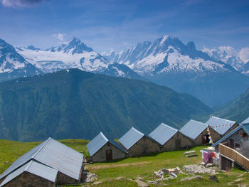 Scenic view of village against mountain range