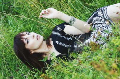 High angle view of woman relaxing on field