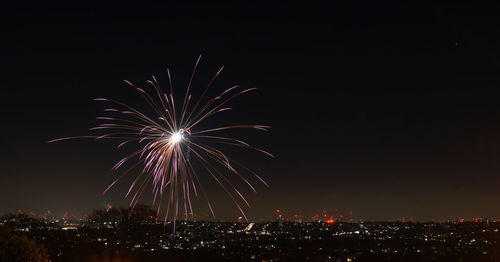 Firework display in sky at night