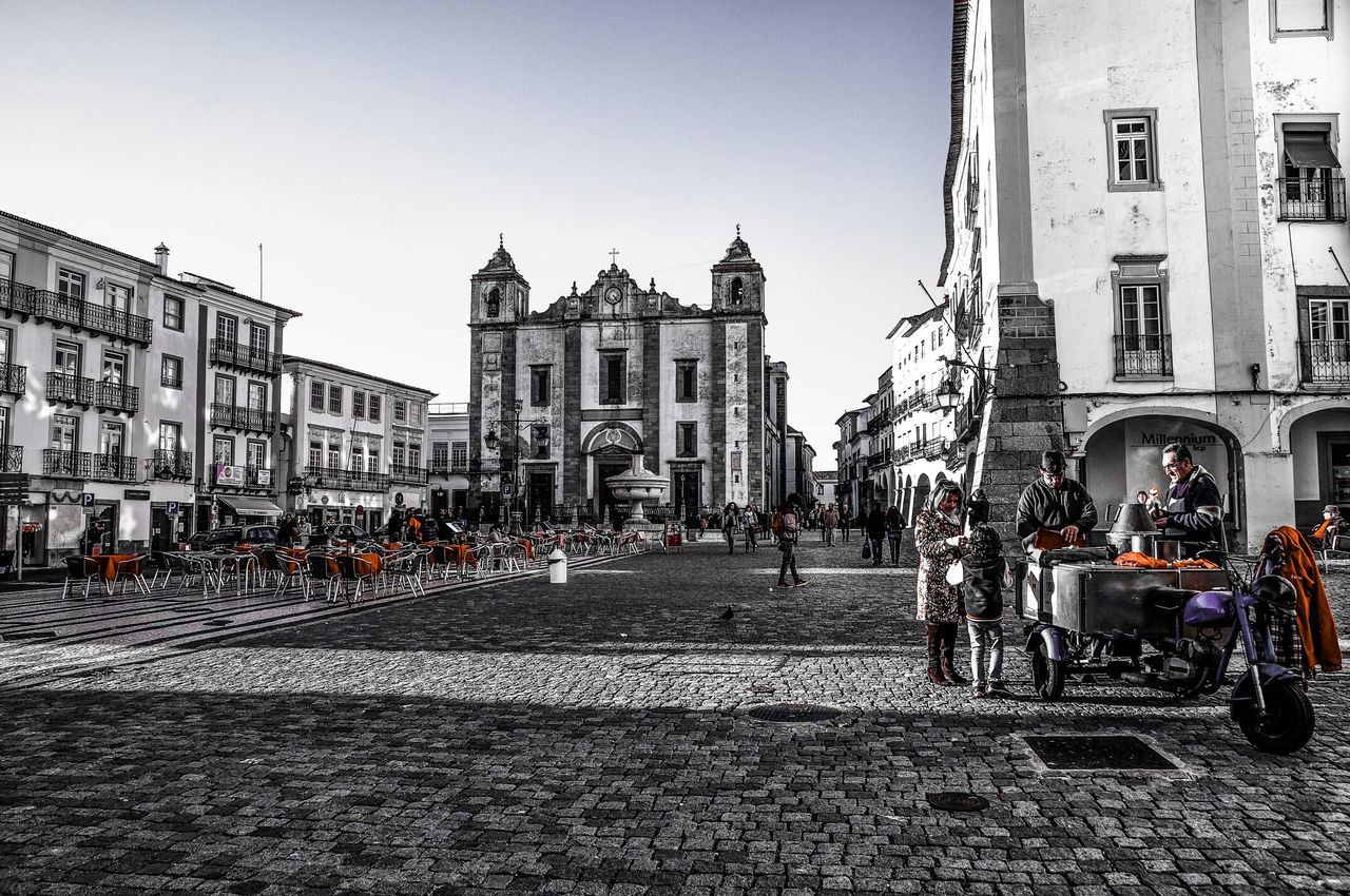 building exterior, architecture, built structure, large group of people, clear sky, street, city, person, men, religion, city life, incidental people, walking, church, place of worship, travel, transportation, lifestyles