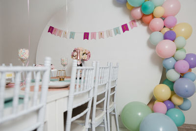 Multi colored balloons on table at home