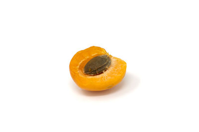 Close-up of orange slice over white background