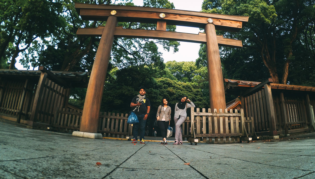 full length, real people, tree, leisure activity, built structure, architecture, outdoors, casual clothing, lifestyles, day, togetherness, young women, walking, wood - material, building exterior, young adult, friendship