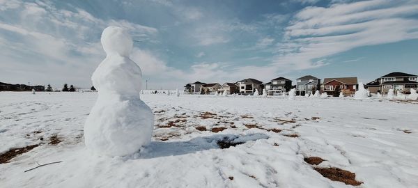 Panoramic shot of snow on field against sky