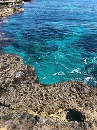 High angle view of rocks by sea