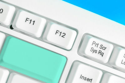 Close-up of computer keyboard blue background