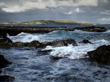 Scenic view of sea against cloudy sky