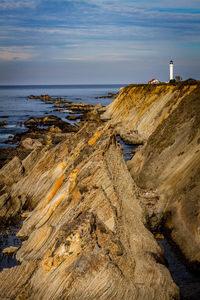 Scenic view of lighthouse and sea against sky