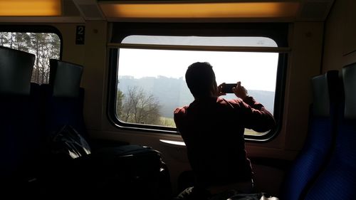 Man photographing in bus