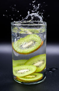 Close-up of drink in glass against black background