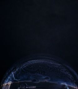 Close-up of bubbles over black background