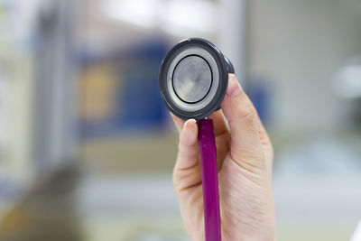 Cropped hand of woman holding stethoscope
