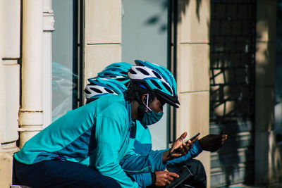 Man riding bicycle sitting outside building