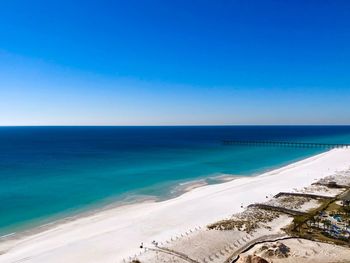 Scenic view of sea against clear blue sky