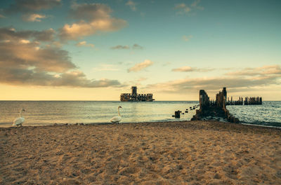 Scenic view of beach against sky during sunset