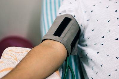 Close-up of man hand on bed