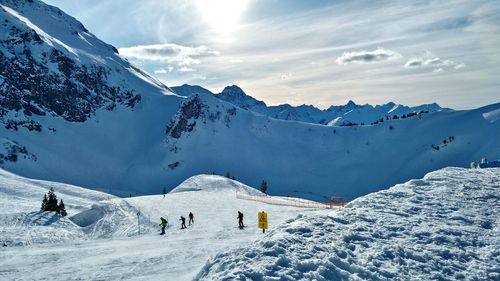 People skiing on snow covered field