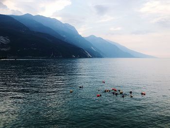 Scenic view of sea and mountains against sky