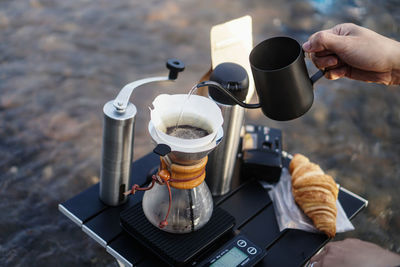 High angle view of hand holding coffee cup