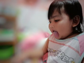 Close-up portrait of cute girl looking away