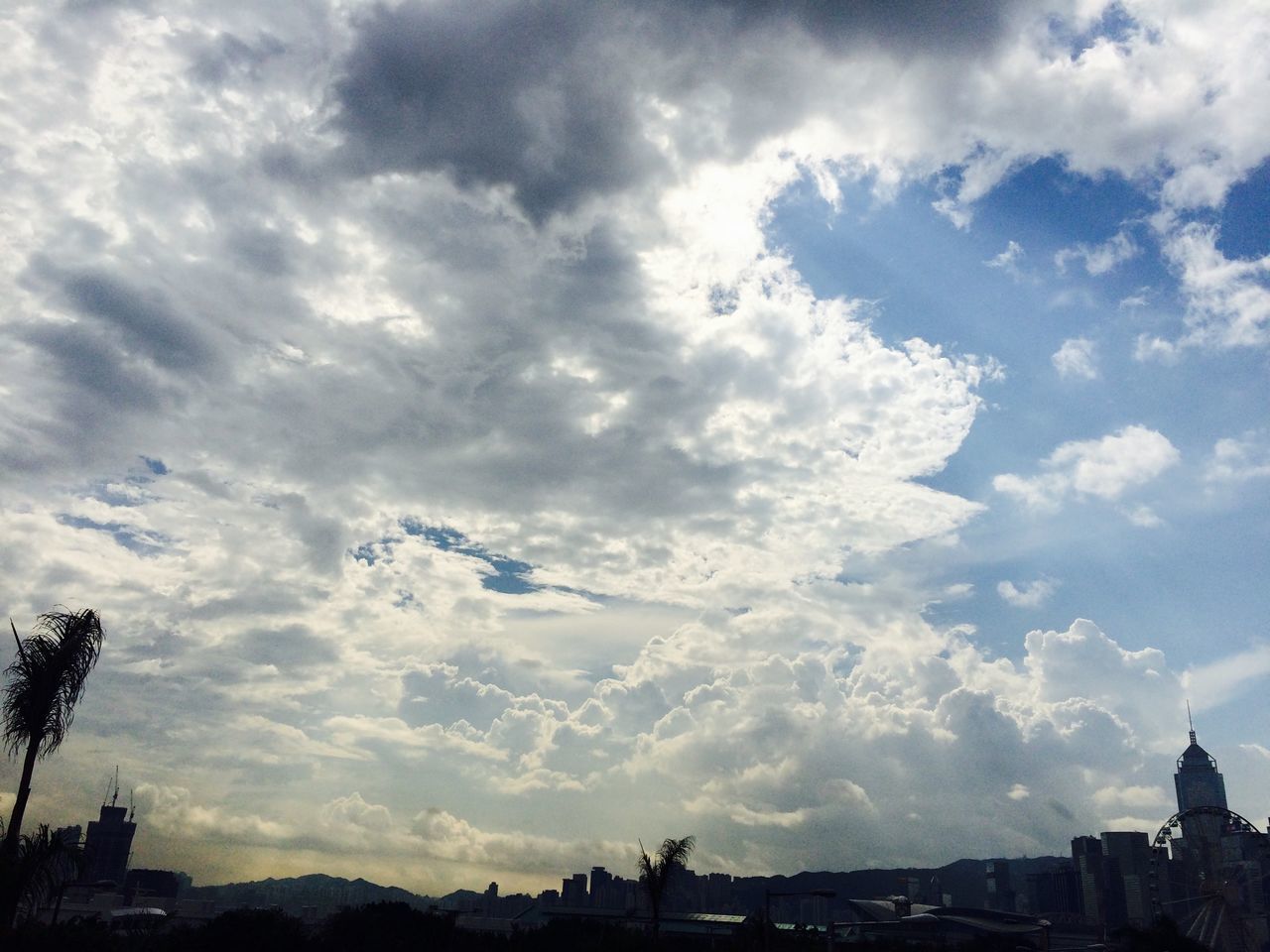 sky, cloud - sky, architecture, built structure, cloudy, building exterior, cloud, city, silhouette, low angle view, tree, nature, weather, overcast, outdoors, cityscape, cloudscape, scenics, beauty in nature, no people