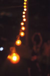 Low angle view of illuminated street lights at night