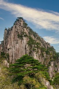 Low angle view of rock formations against sky