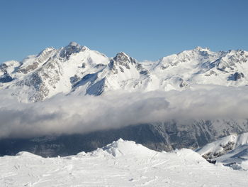 Scenic view of snowcapped mountains against clear blue sky