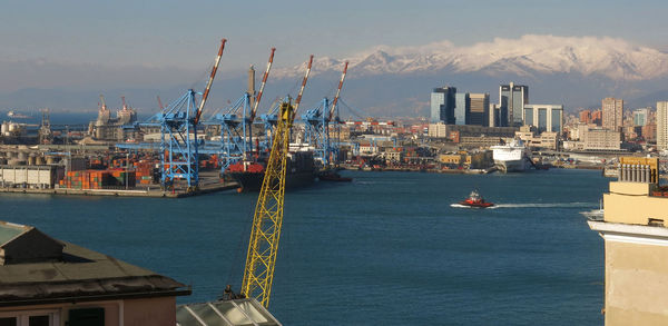 Commercial dock by sea against sky