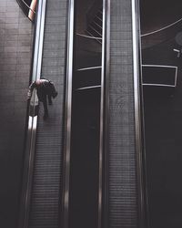 Low angle view of man walking on escalator