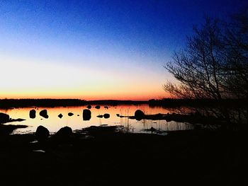 Scenic view of calm lake at sunset