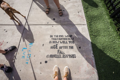 Low section of person standing on tiled floor