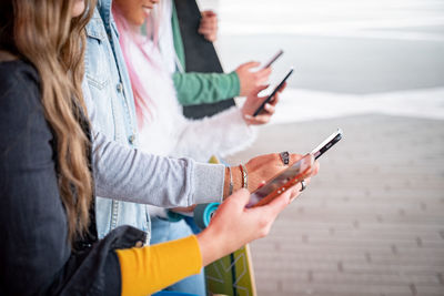 Midsection of woman using mobile phone