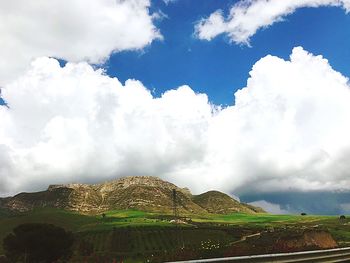 Low angle view of mountain against cloudy sky