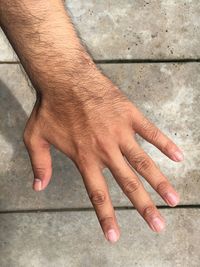 Close-up of man hand gesturing against wall