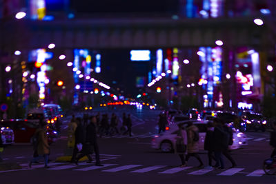 People on city street at night