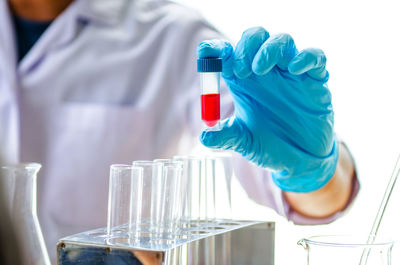 Midsection of scientist working in laboratory