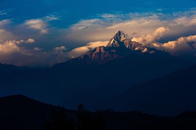 Scenic view of mountain peak against sky at sunset