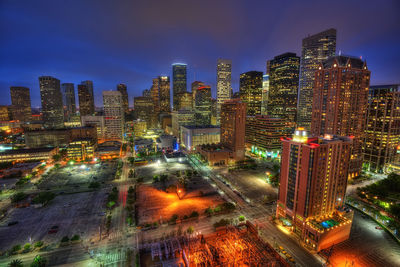 Aerial view of illuminated city buildings at night