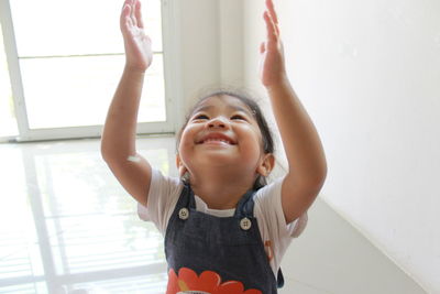 Close-up of happy girl playing at home