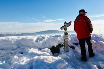 Man walking on snow against sky