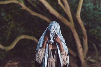 Midsection of man in forest