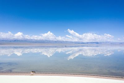 Scenic view of sea against blue sky