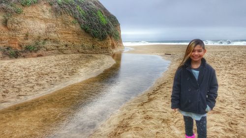High angle view of woman standing by sea