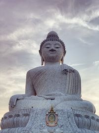 Low angle view of statue against cloudy sky