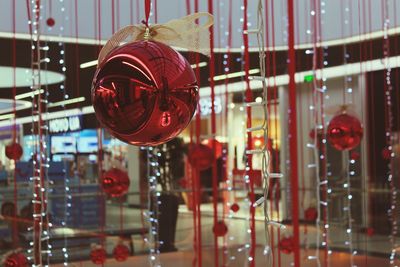 Close-up of illuminated lighting equipment hanging on ceiling