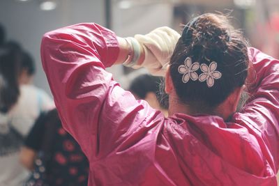 Rear view of woman wearing pink raincoat