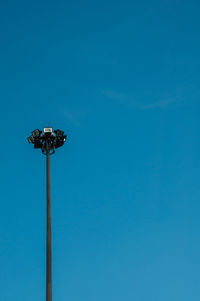 Low angle view of street light against blue sky