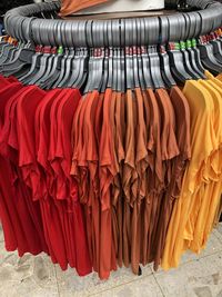 Clothes hanging in a row at store
