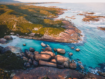 High angle view of rocks on sea shore